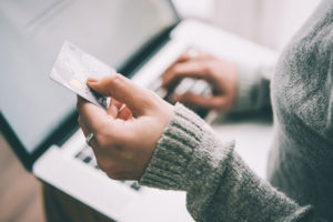 a dental implant patient using a credit card to pay for a procedure