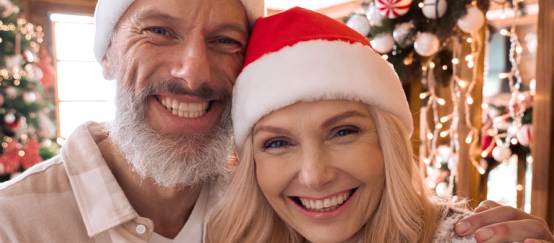 Dental Implant Patients Smiling During A Holiday Party